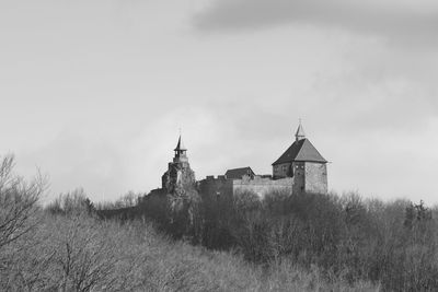 Old building on field against sky