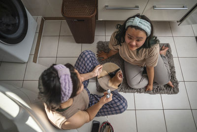 Asian teen beauties begin their morning routine with masking pimples and facial massage in  bathroom