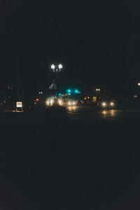 Illuminated city against clear sky at night