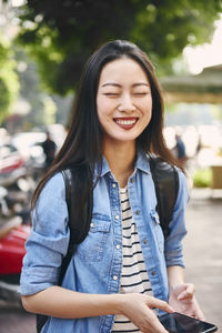 Beautiful woman smiling while standing outdoors