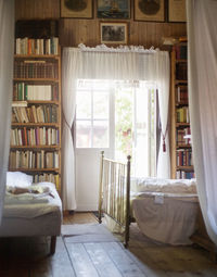 Interior of a bedroom with books arranged in shelf