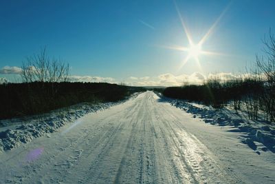 Snow covered landscape against clear sky