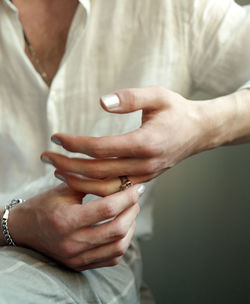 Midsection of couple holding hands