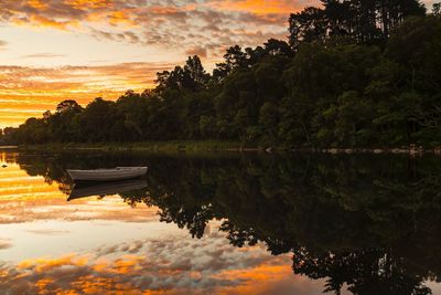 Scenic view of lake against sky during sunset