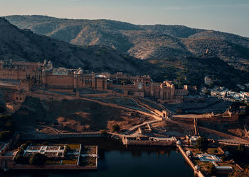 High angle view of buildings and mountains against sky