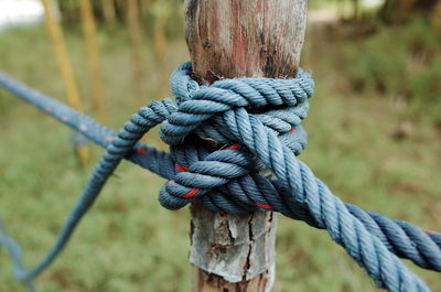 Close-up of rope tied on wooden post