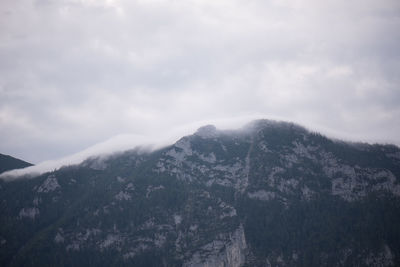 Scenic view of mountains against cloudy sky