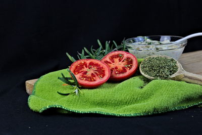 Close-up of fruit on table against black background