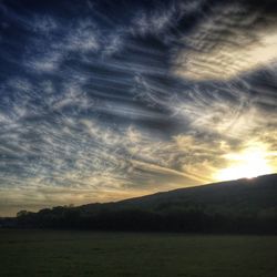 Scenic view of landscape against cloudy sky