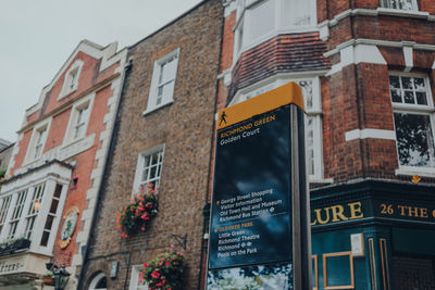 Low angle view of text on building against sky