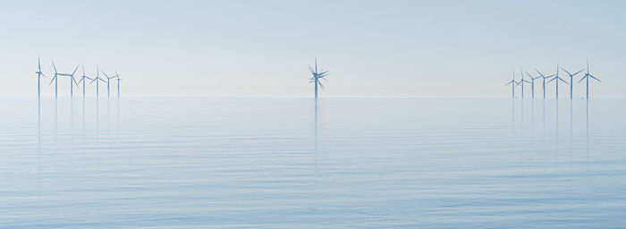 Offshore wind turbines generating renewable electricity and energy  background image