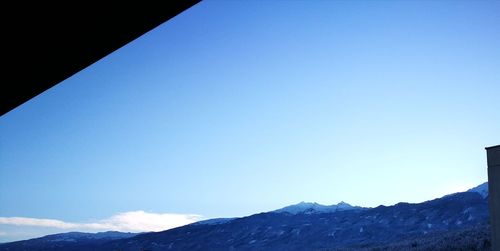 Low angle view of mountains against clear blue sky