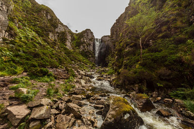 Scenic view of waterfall against sky