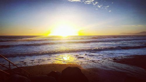 Scenic view of beach against sky during sunset