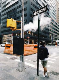 Rear view of man walking on city street