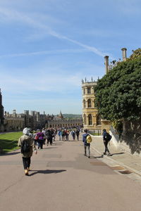 Tourists walking around the st george's chapel inside the windsor castle on a sunny day in spring