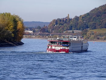Boat sailing on river against sky
