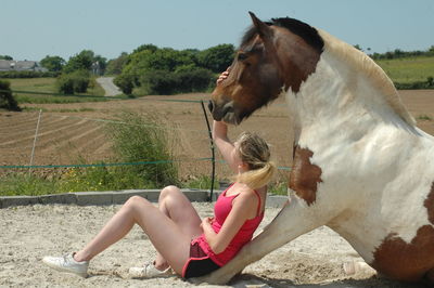 Woman with horse on field