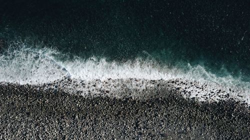 High angle view of waves on beach