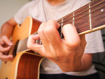 Close-up of man playing guitar