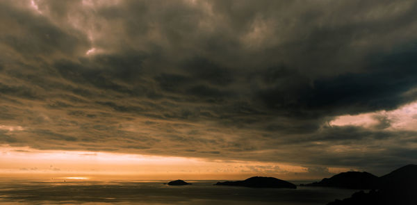 Scenic view of dramatic sky over sea during sunset