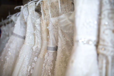 Close-up of wedding dresses in bridal shop