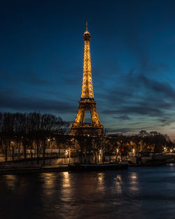 View of illuminated tower against sky in city