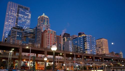 Low angle view of illuminated buildings against sky at night