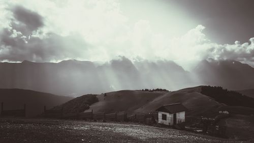 Panoramic view of houses and mountains against sky