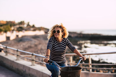 Woman wearing sunglasses riding bicycle