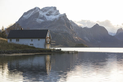 Scenic view of lake by mountain against sky