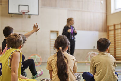 Children having class in school gym