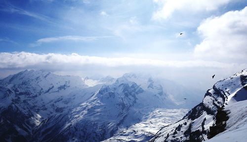 Scenic view of mountains against cloudy sky