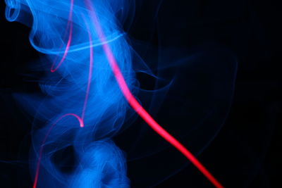 Close-up of light painting against black background