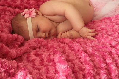 Close-up of baby sleeping on bed