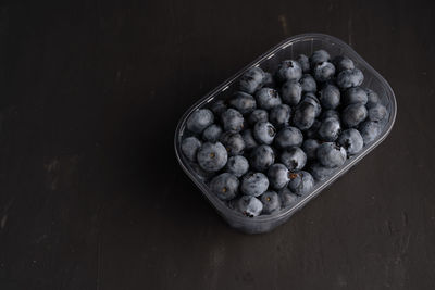 High angle view of blueberries in bowl on table
