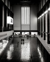 People walking in illuminated building