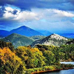 Scenic view of mountains against cloudy sky