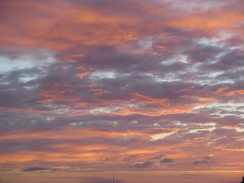Low angle view of cloudy sky at sunset