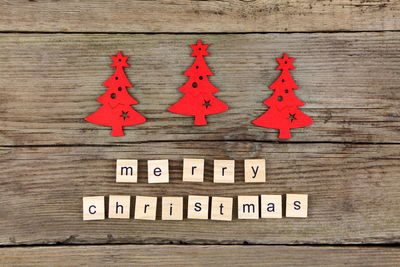 Close-up of text on wooden blocks with artificial christmas tree at table