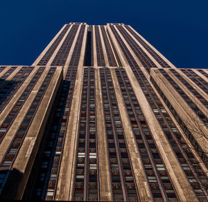 Low angle view of modern building against clear blue sky