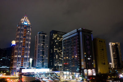 Illuminated modern buildings in city at night