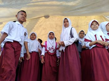 High angle view of friends standing against the wall