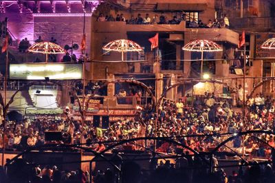 Group of people in front of illuminated building at night