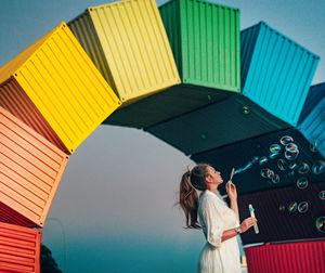Midsection of woman standing in corridor