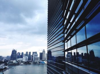 View of skyscrapers against cloudy sky