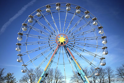 Low angle view of ferris wheel against sky