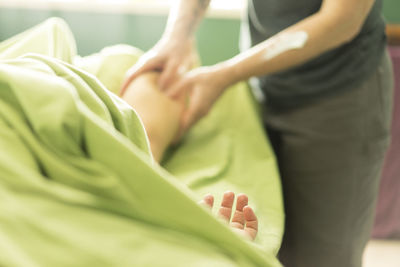 Message therapist massaging woman at spa