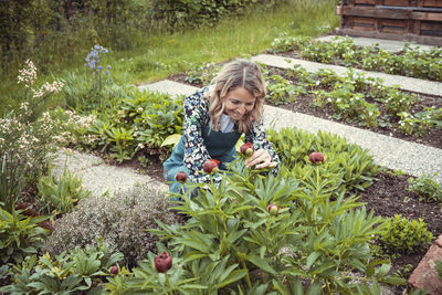 Young woman standing amidst plants