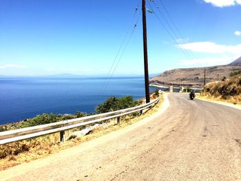 Road by sea against sky